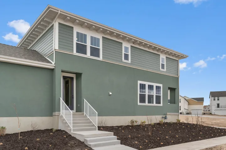 Contemporary exterior featuring green stucco and horizontal siding