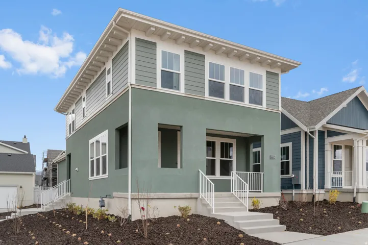 Contemporary exterior featuring a two-tone facade with a smooth stucco base and horizontal siding