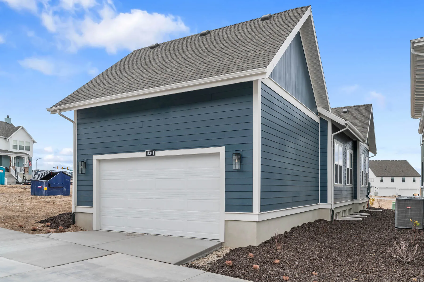 Contemporary residence featuring blue siding, white trim, a single-car garage, and concrete driveway