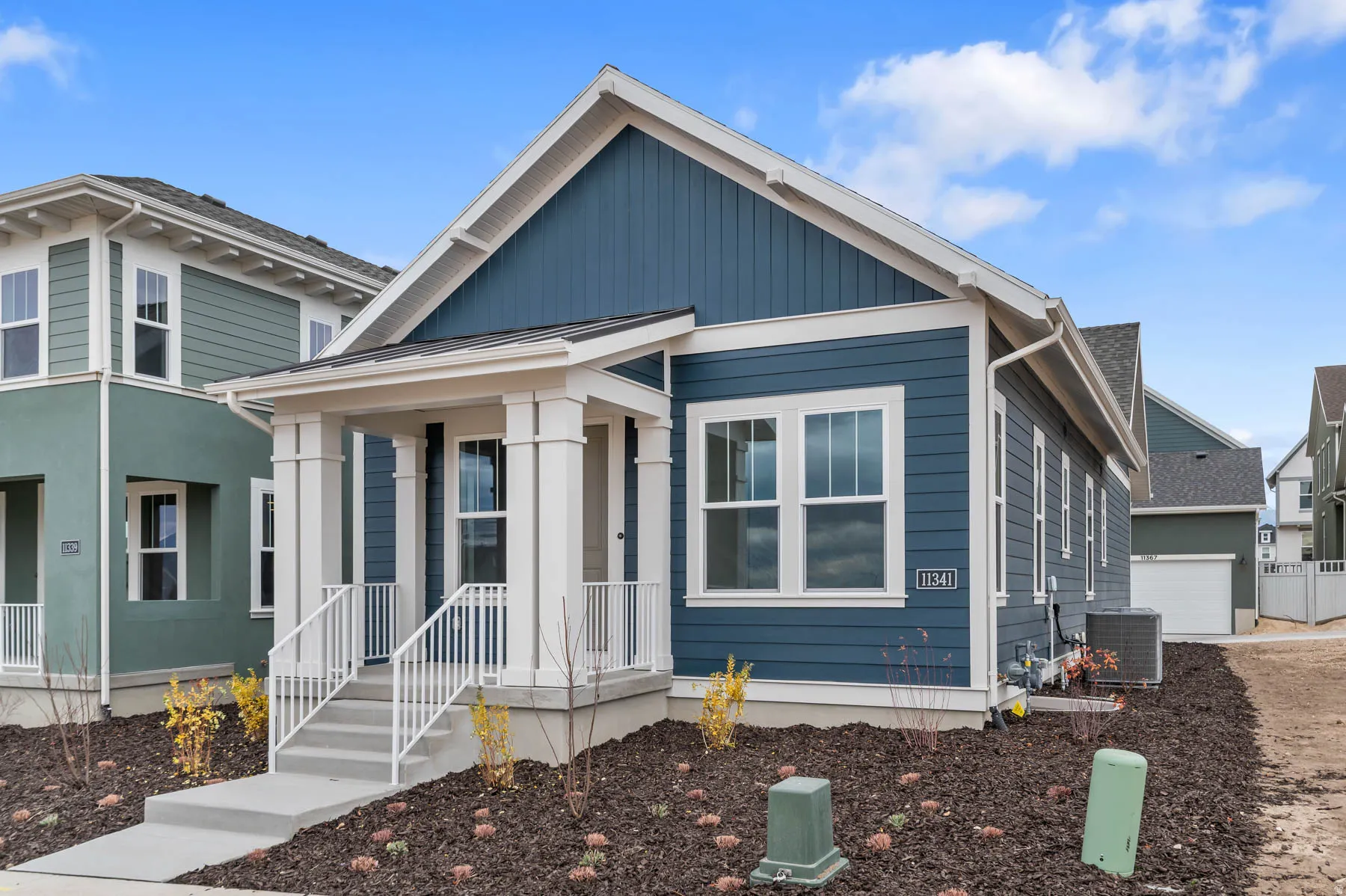 Exterior featuring blue siding and white trim accents