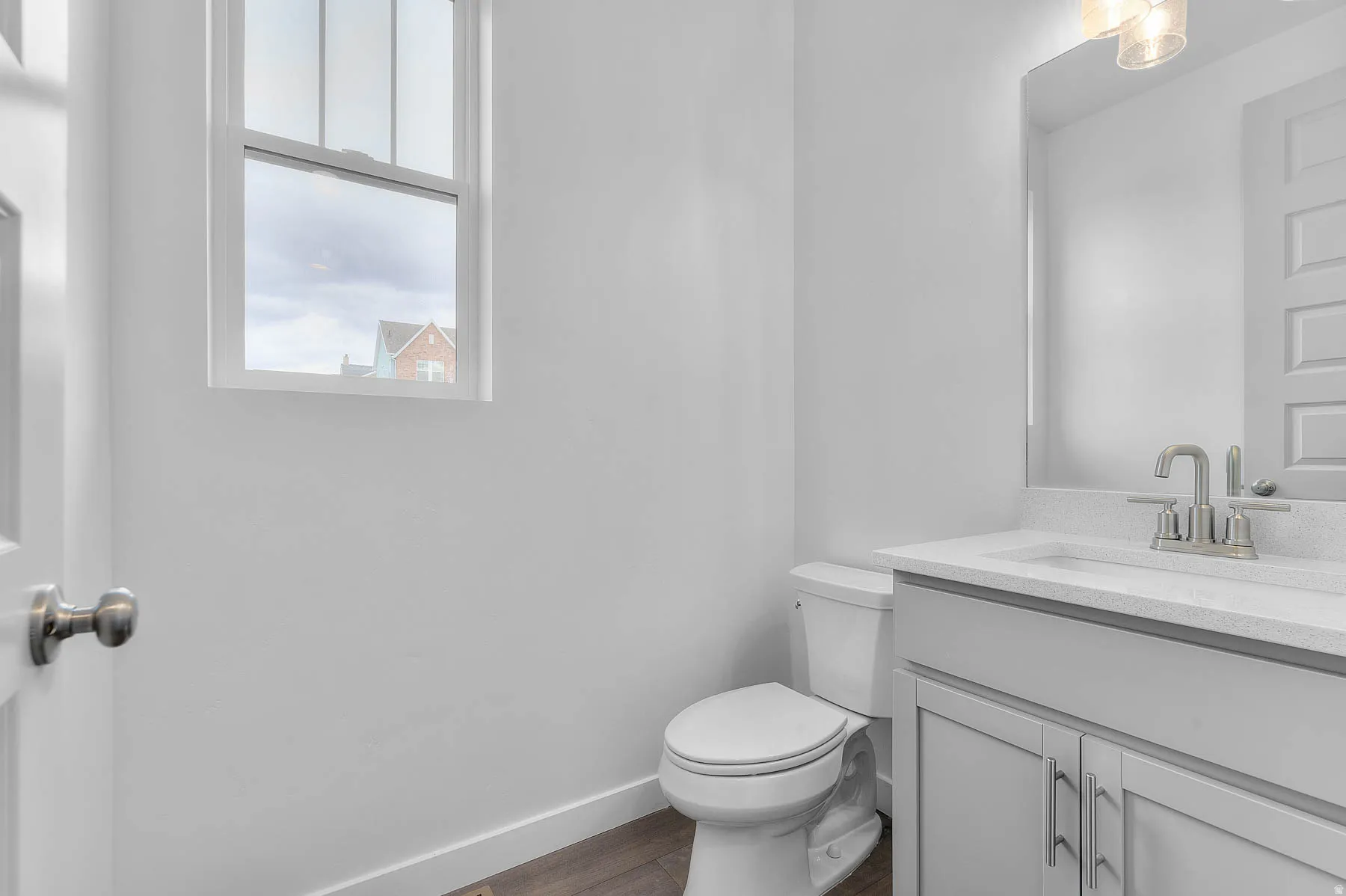 Bathroom featuring a white vanity with a light-colored countertop, undermount sink, and brushed nickel faucet