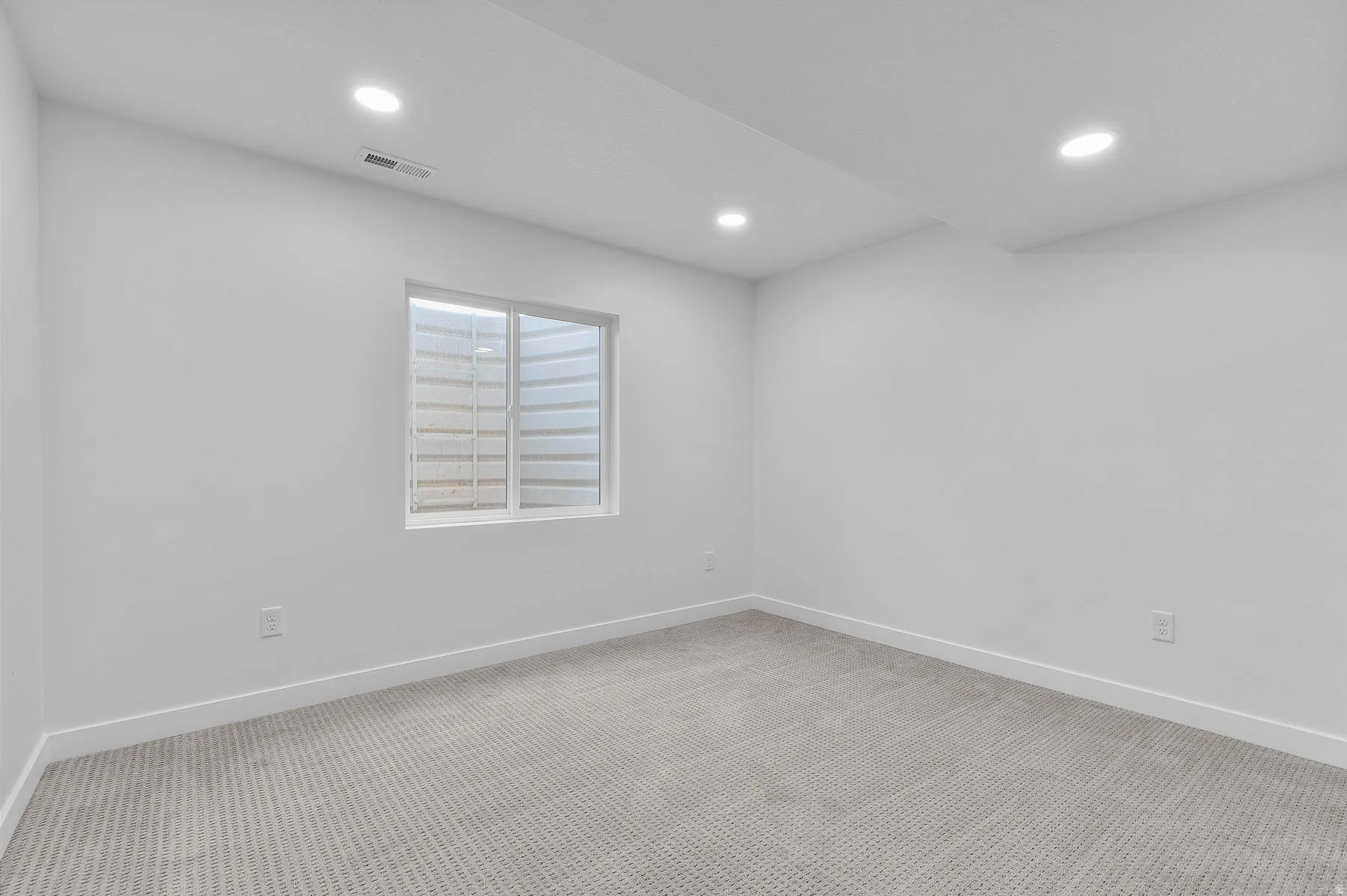 Room featuring neutral wall finishes and patterned carpet flooring