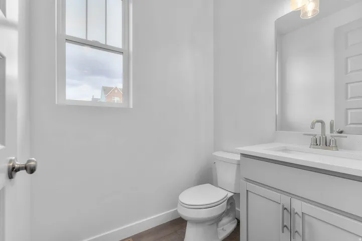 Bathroom featuring a white vanity with a light-colored countertop, undermount sink, and brushed nickel faucet