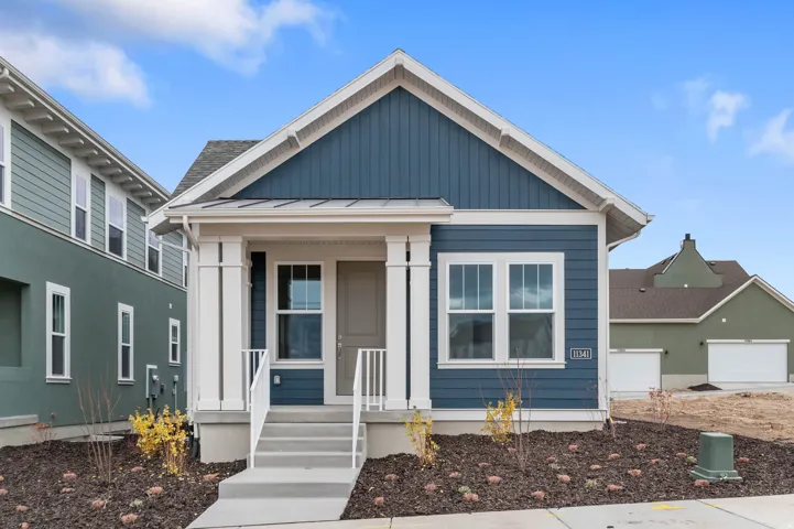 Modern cottage-style exterior featuring blue siding and vertical accents