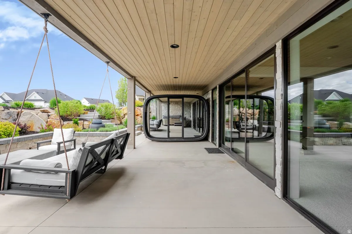 Covered outdoor patio featuring a wood-finish plank ceiling and recessed lighting