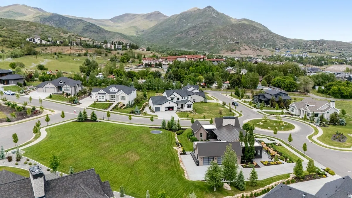 Expansive residential development featuring a variety of architectural styles, surrounded by natural mountainous terrain