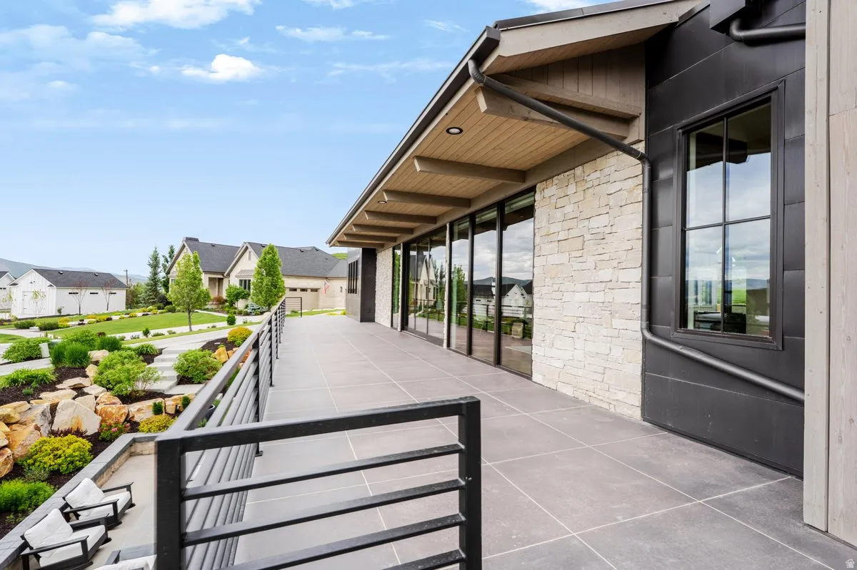 Expansive elevated patio featuring large format tile flooring and contemporary metal railings