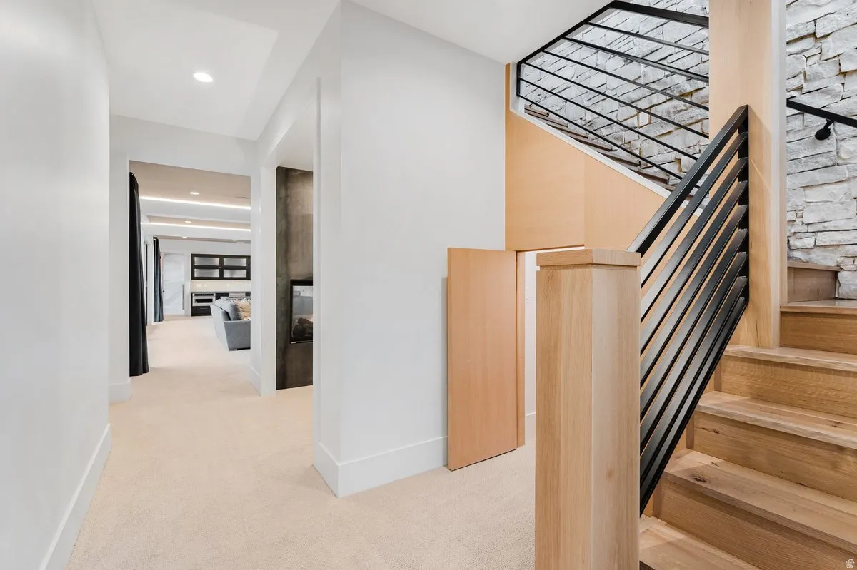 Crafted wood staircase with a sleek black iron railing