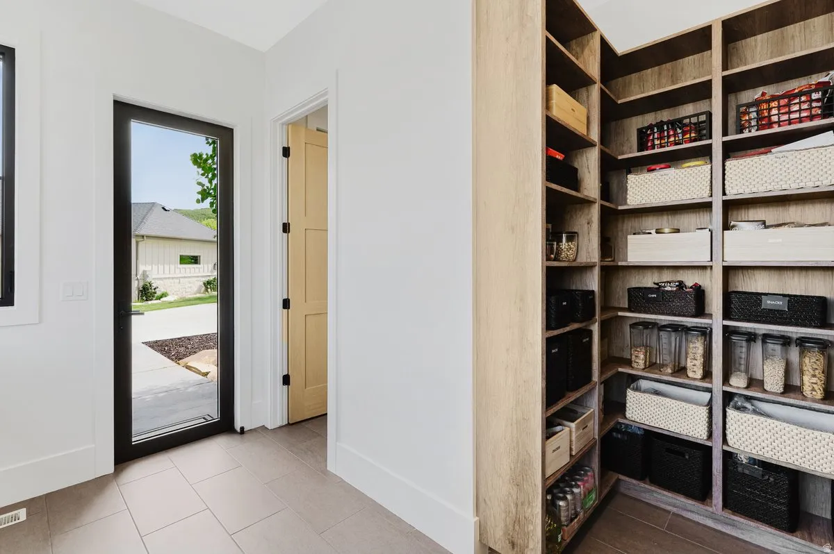 Spacious walk-in pantry with extensive wood-finish shelving