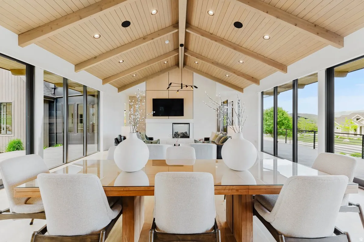 Vaulted wood-paneled ceiling with exposed beams and recessed lighting