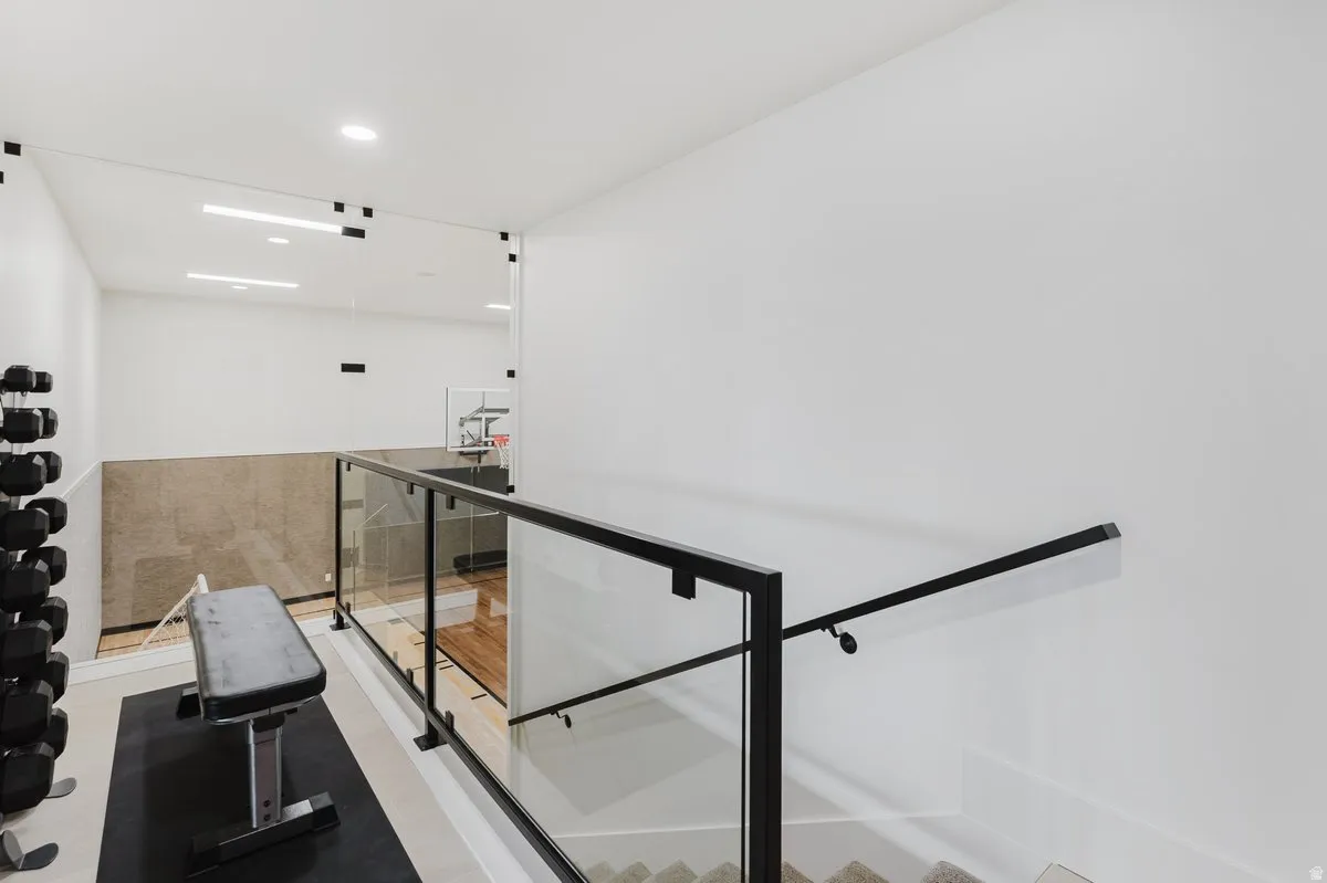 Modern interior featuring a glass and black metal railing system