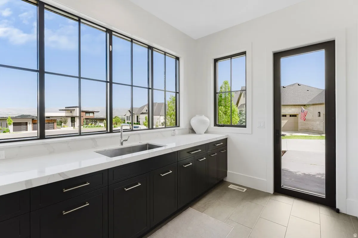 Expansive wall of black-framed grid windows, offering abundant natural light
