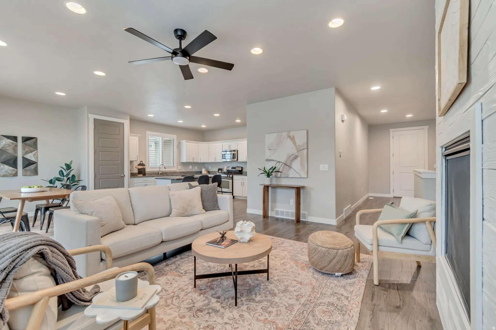 Expansive living area featuring recessed lighting, a ceiling fan, and wood-finish flooring
