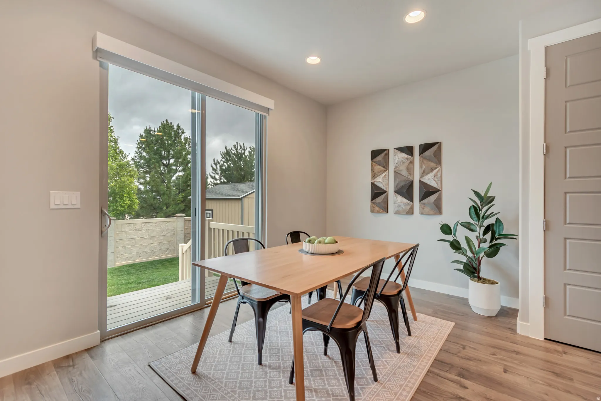 Spacious room featuring wood-finish flooring, recessed lighting, and a neutral color palette