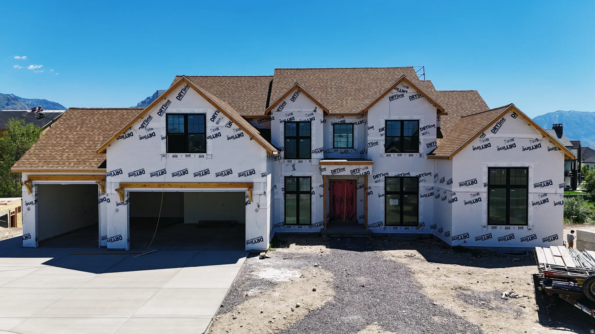 Newly constructed residence featuring a multi-gable roofline and modern black-framed windows