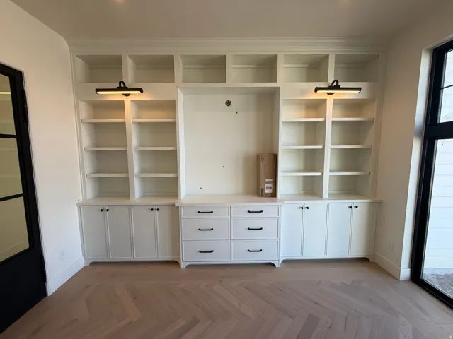 Built-in cabinetry with integrated shelving, drawer storage, and black hardware