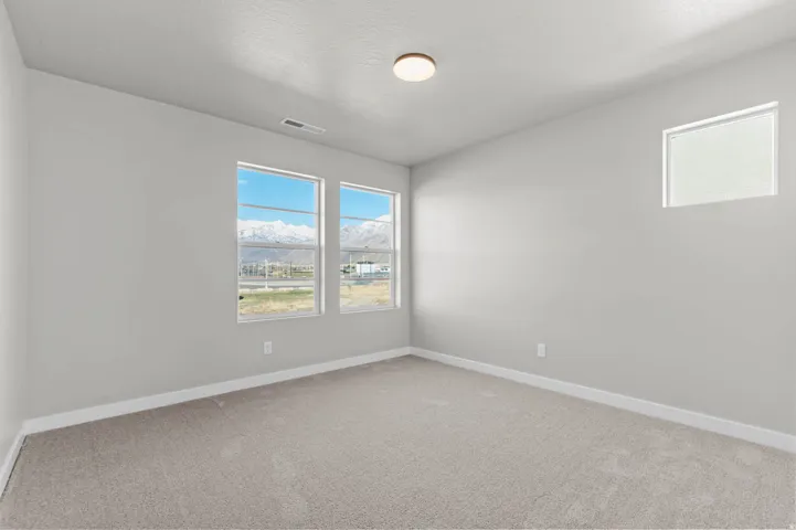 Carpeted room featuring light gray walls and white trim