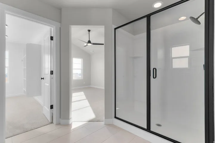 Black-framed glass shower enclosure with a rainfall showerhead