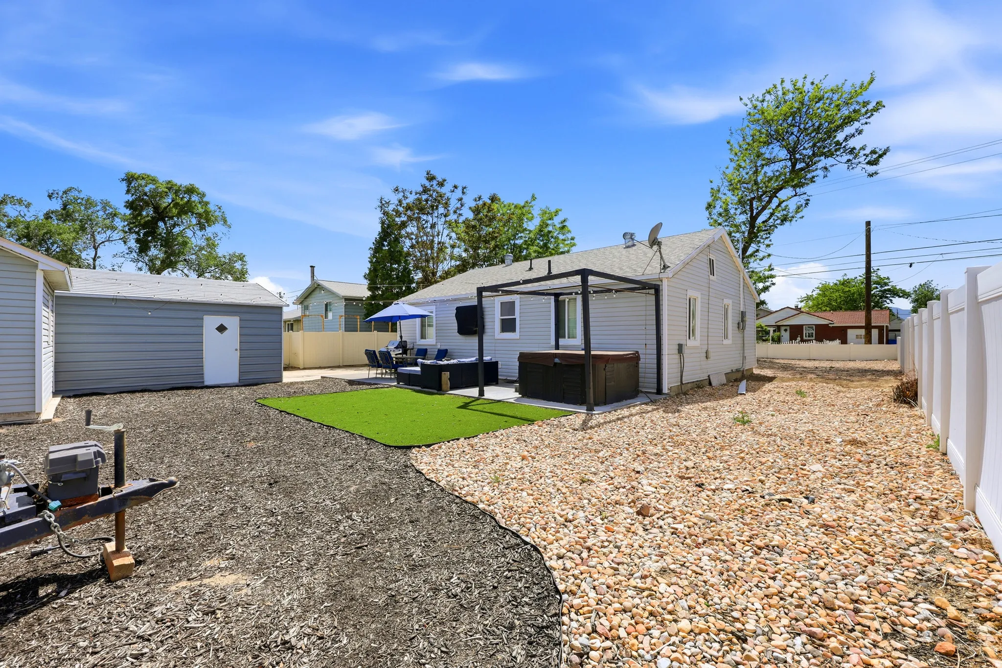 Backyard featuring a vinyl privacy fence, a detached shed, and a dedicated patio area