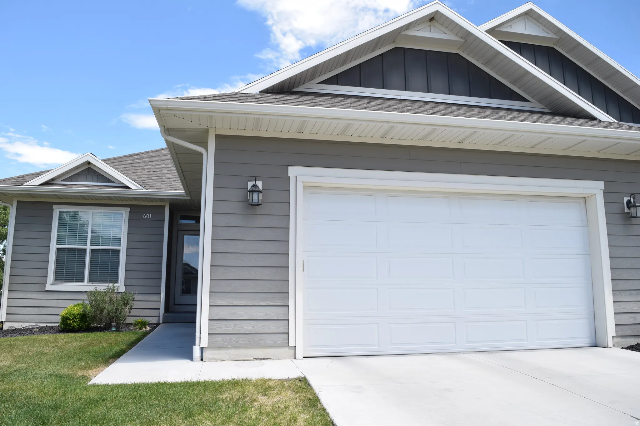 Gray siding exterior with white trim details and a pitched roofline