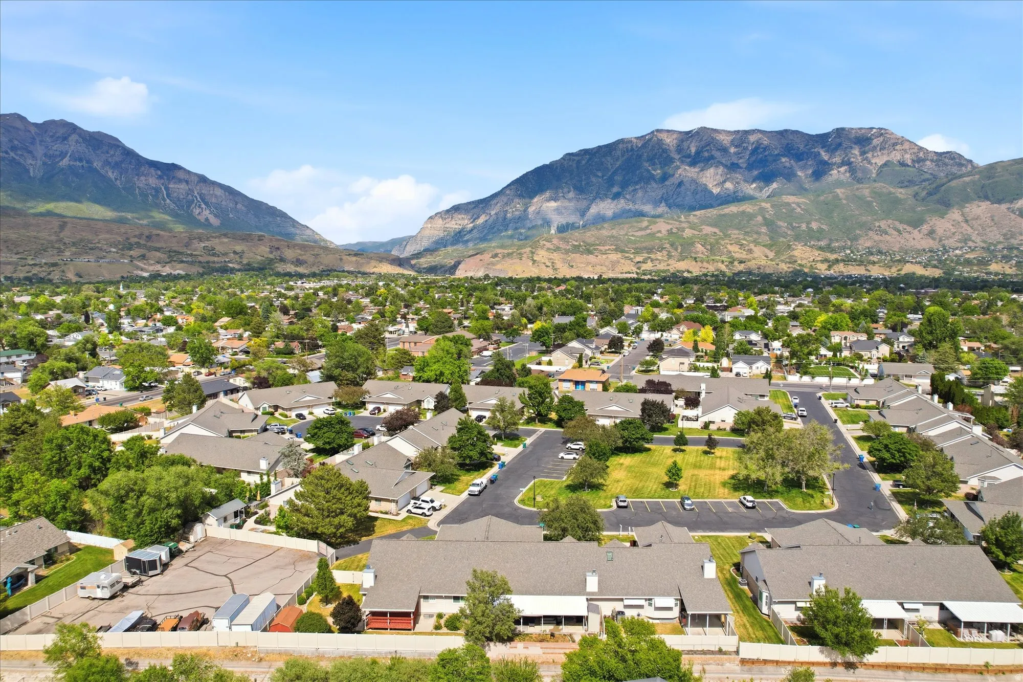 Expansive residential community featuring a variety of homes, mature trees, and mountain scenery