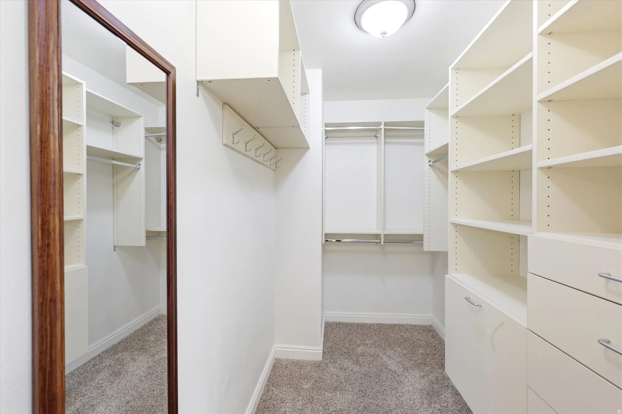 Custom closet system featuring extensive shelving, hanging rods, and integrated drawers