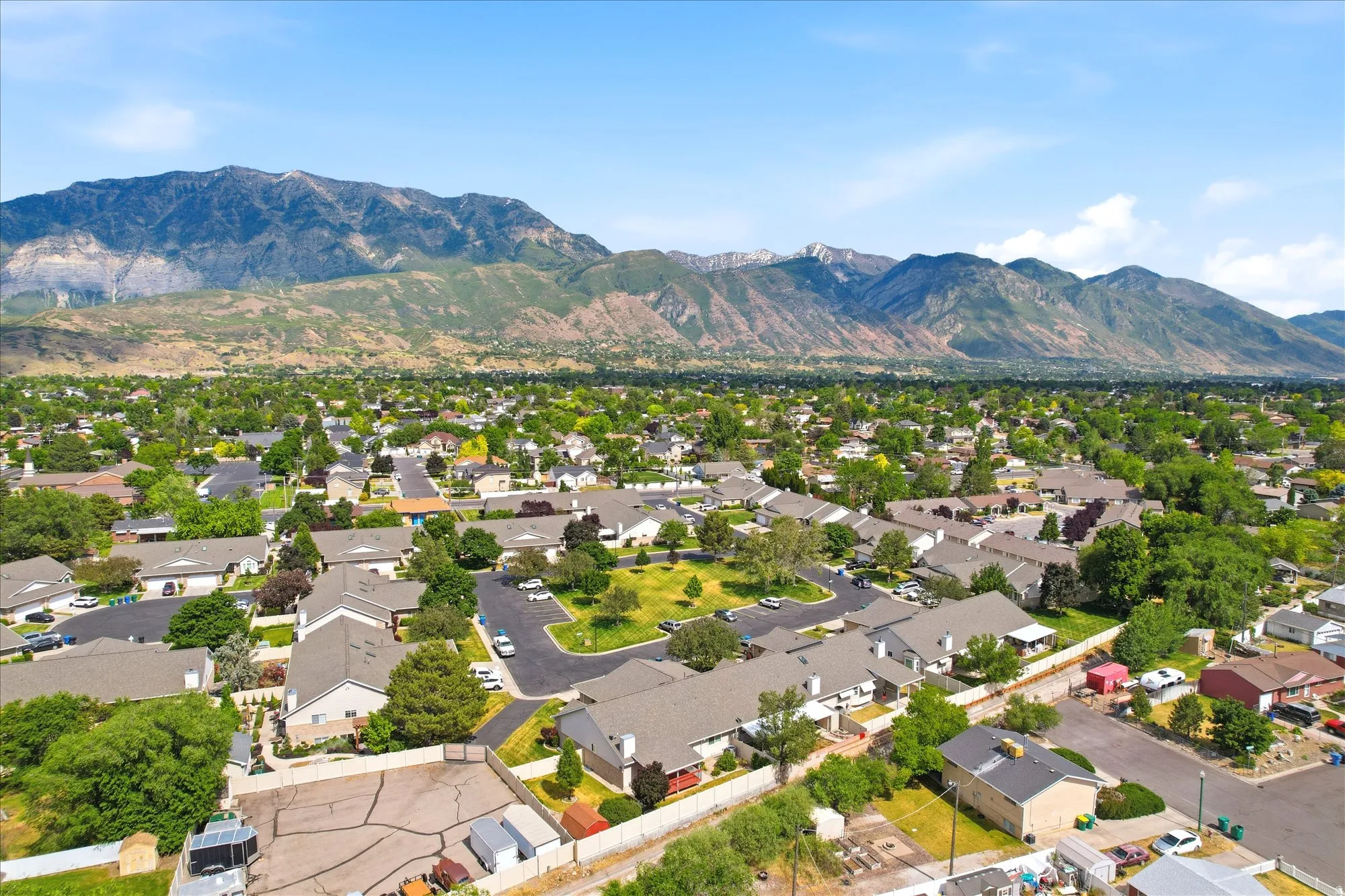 Expansive mountain backdrop framing a residential community with mature landscaping