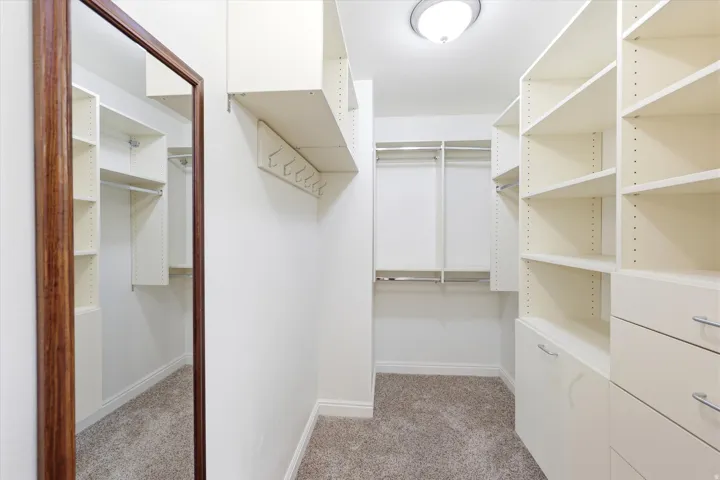 Custom closet system featuring extensive shelving, hanging rods, and integrated drawers