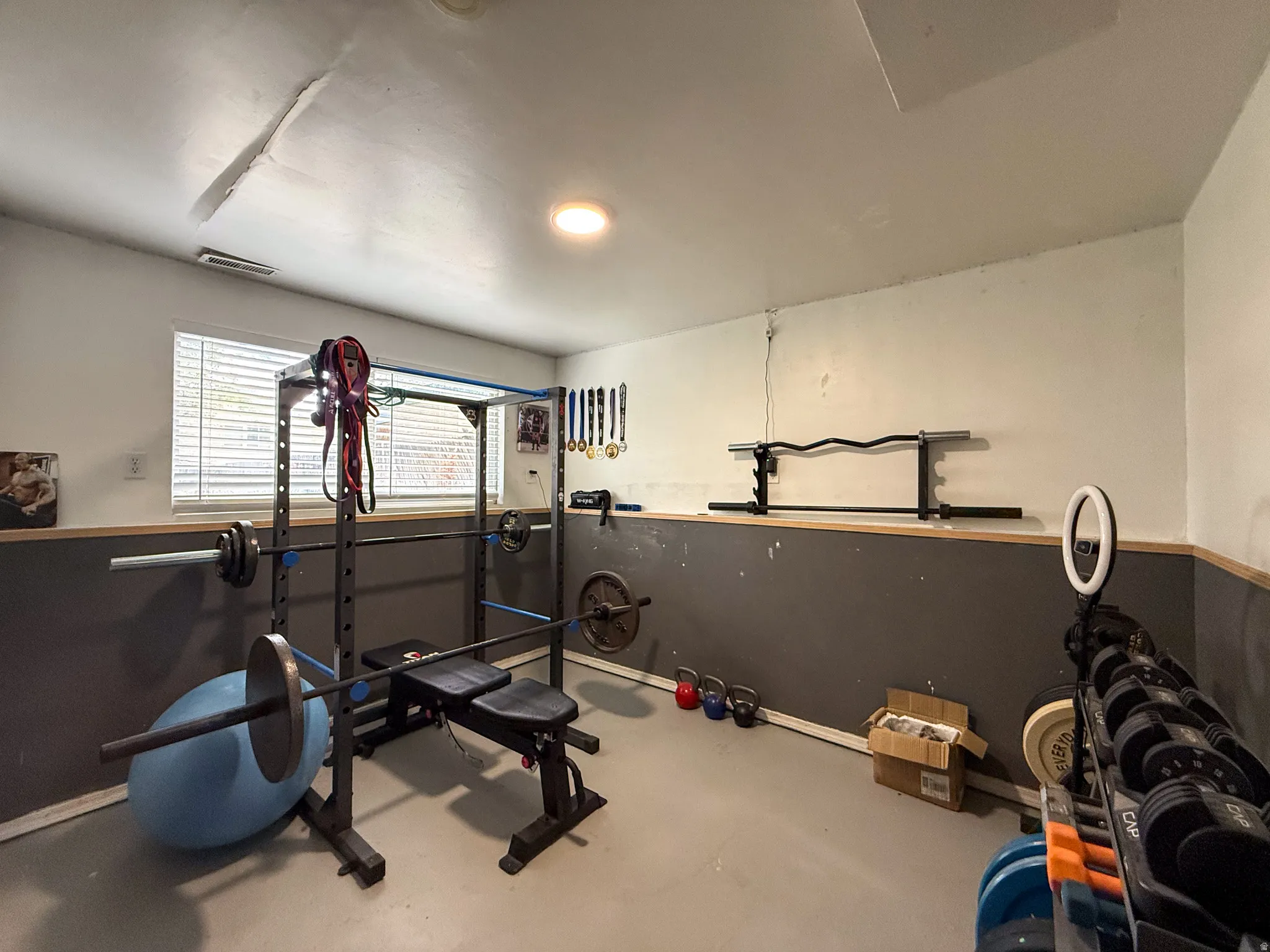Recreational room with a two-tone wall treatment and light-colored flooring