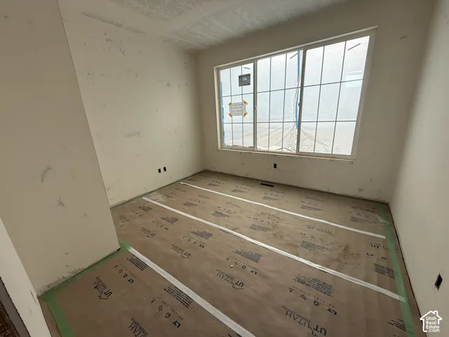 Room featuring a large, multi-pane grid window and neutral wall finishes