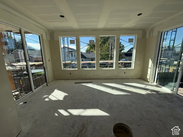 Bright interior with multiple large windows and two sliding glass doors