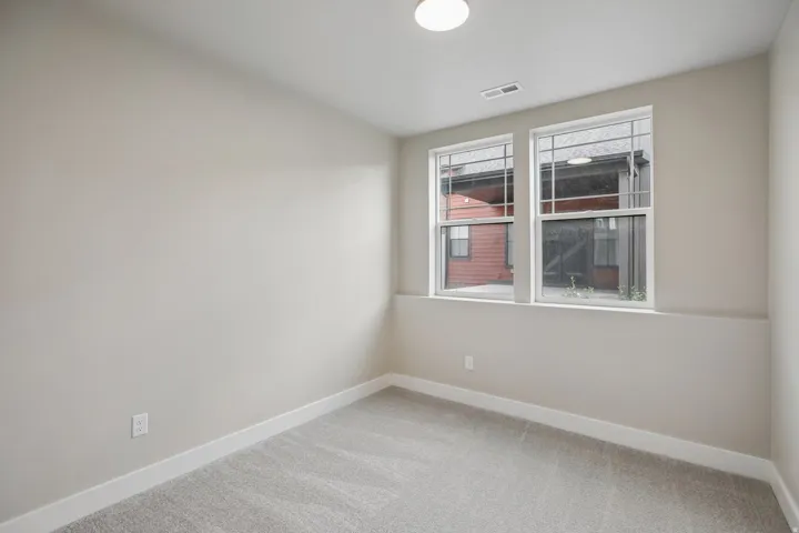 Neutral-toned walls complementing plush grey carpeting