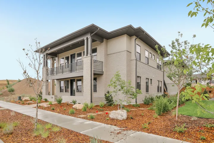 Contemporary exterior featuring light brick and stucco finishes