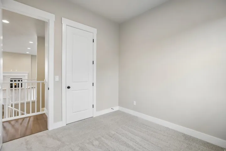 Interior room featuring light gray carpeting and neutral wall tones