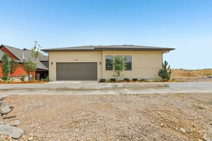 Contemporary stucco exterior with an integrated two-car garage