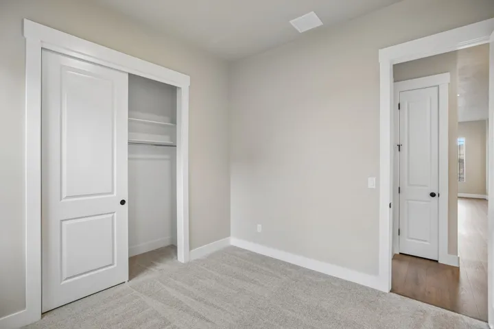 Room featuring light gray wall paint and complementary gray carpeting