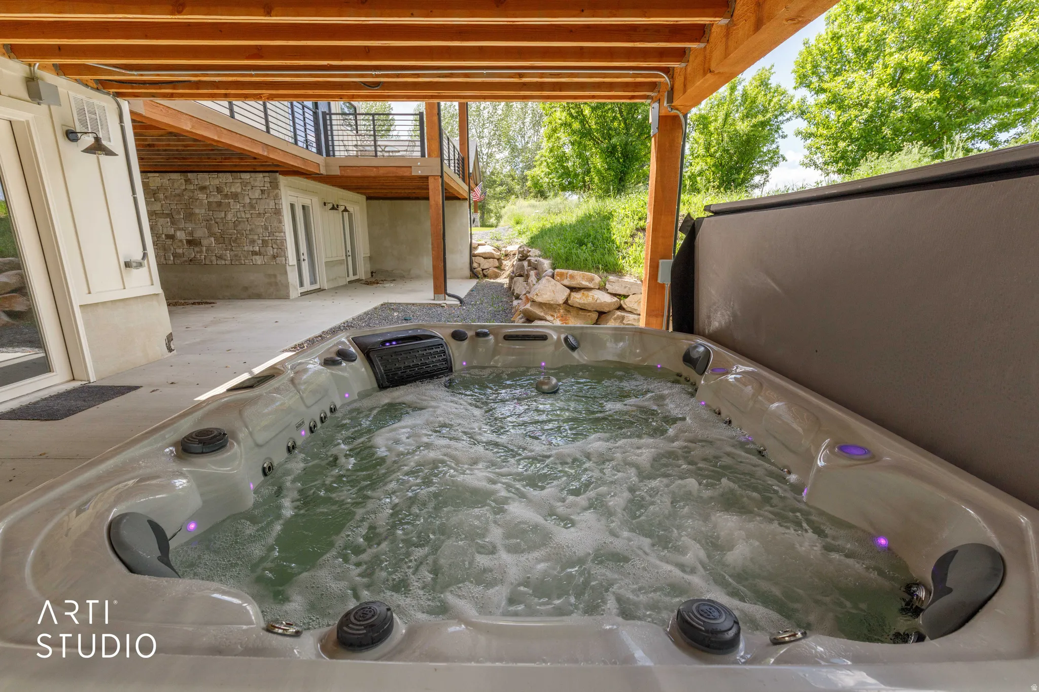 Outdoor hot tub with integrated lighting, set on a concrete patio