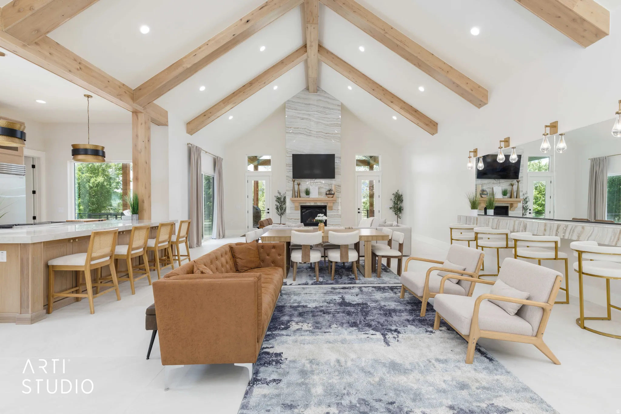 Vaulted ceilings with exposed wood beams define this open-concept living space