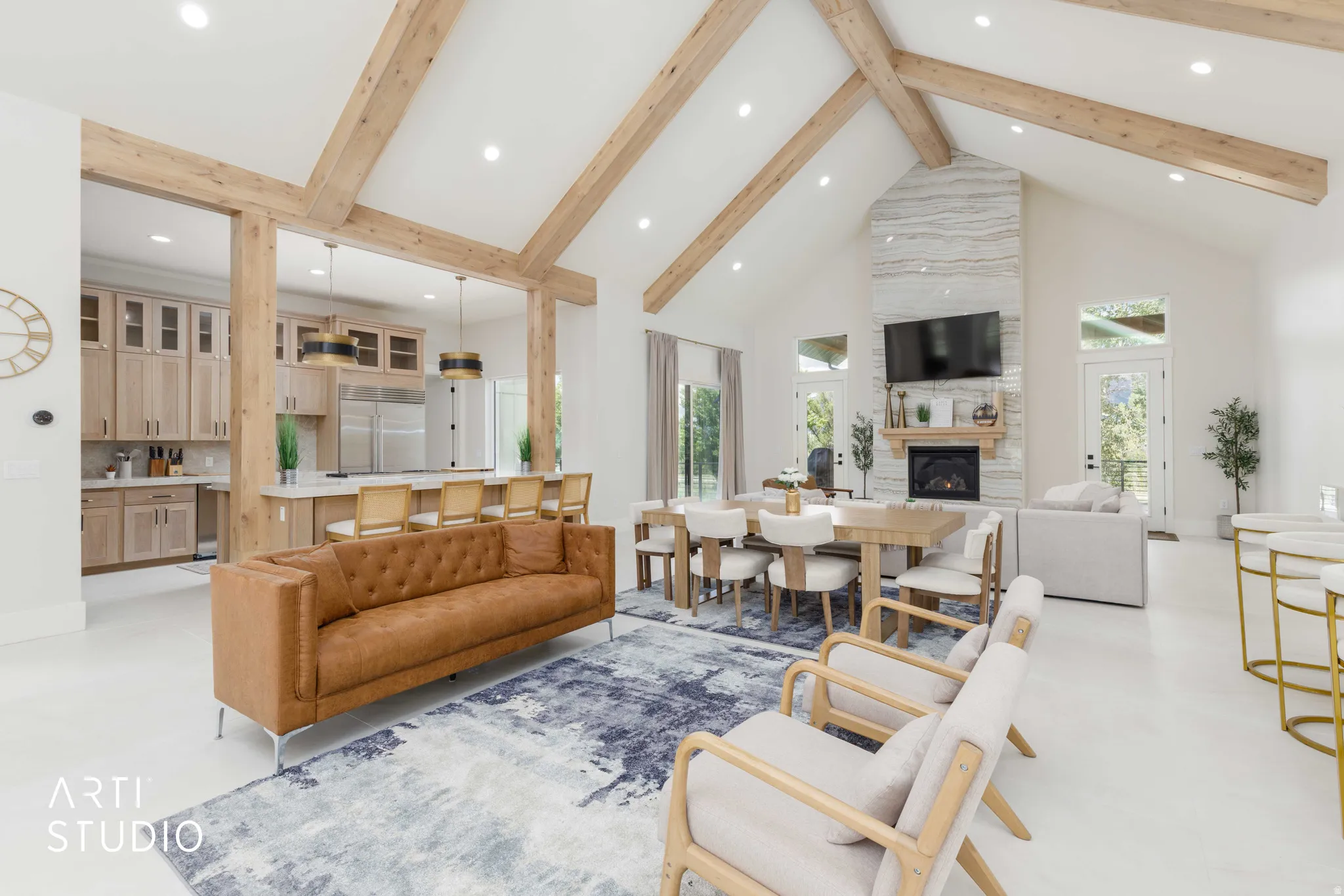 Vaulted ceilings with exposed wood beams define this open-concept living area