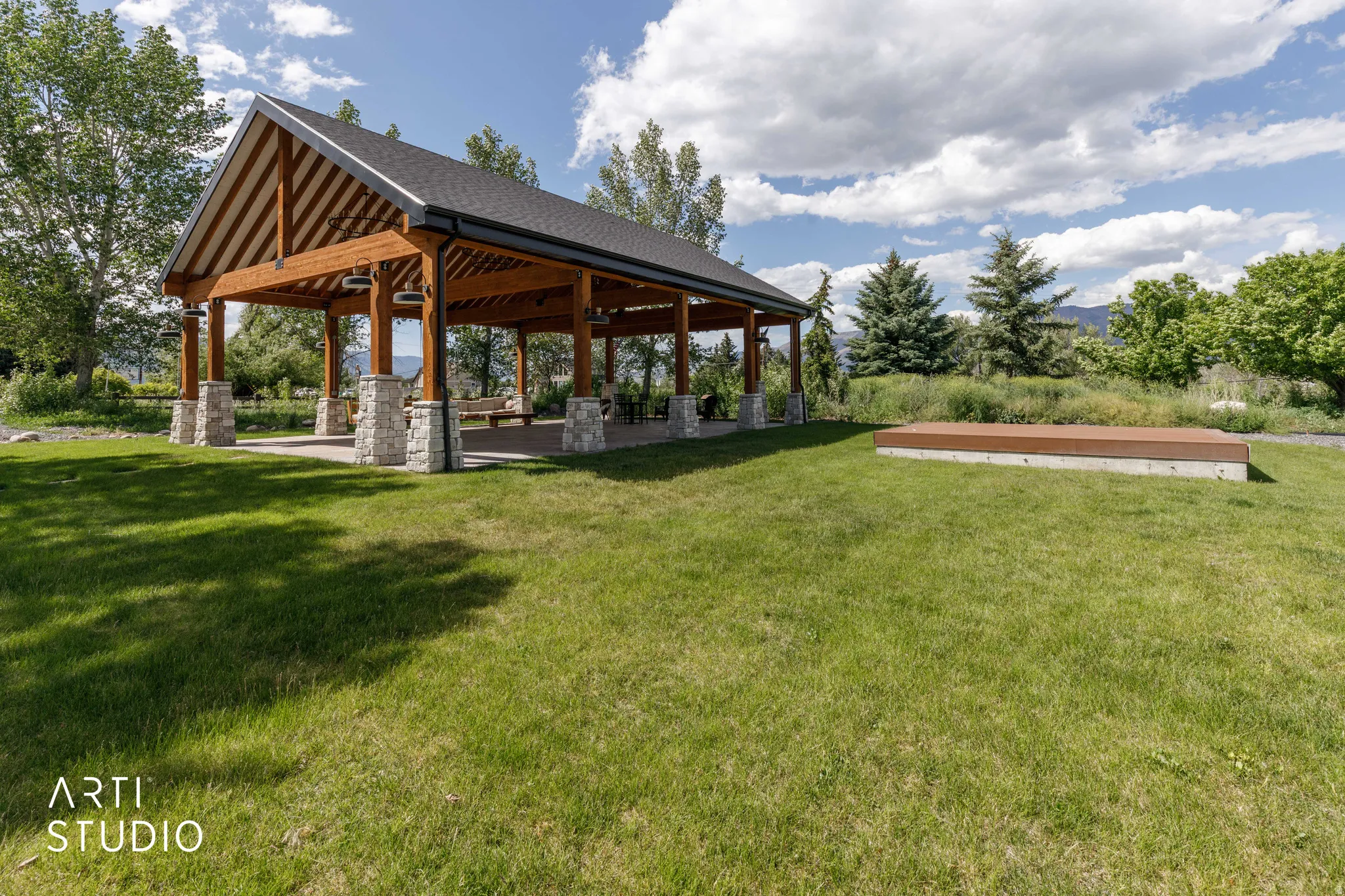 Expansive outdoor pavilion featuring a vaulted ceiling and exposed timber framing