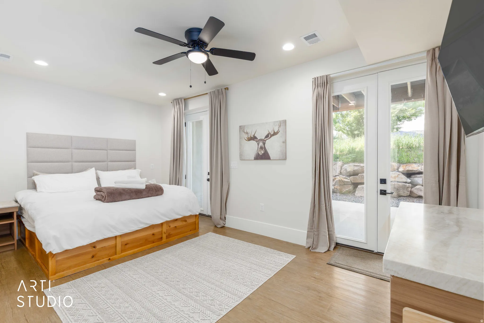 Spacious room featuring wood-finish flooring, recessed lighting, and a ceiling fan
