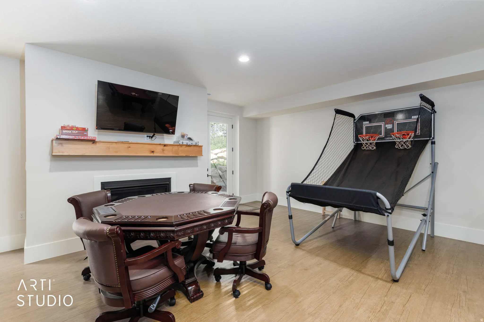 Entertainment room featuring wood-finish flooring and a white color palette