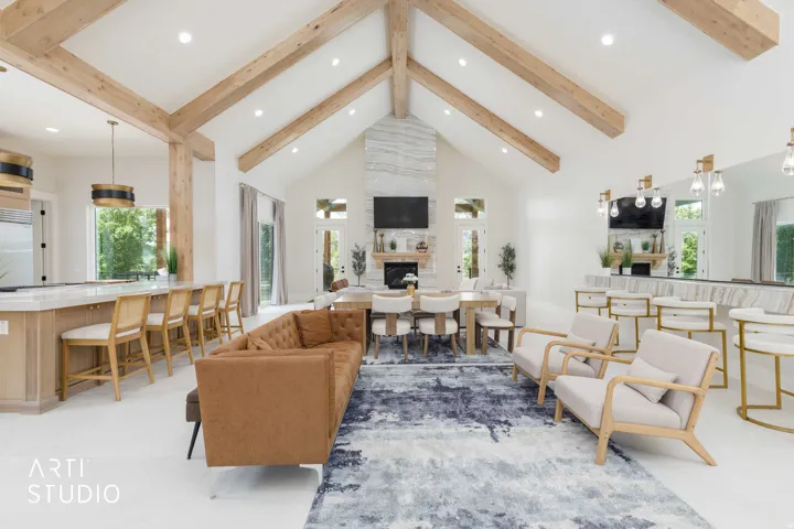 Vaulted ceilings with exposed wood beams define this open-concept living space