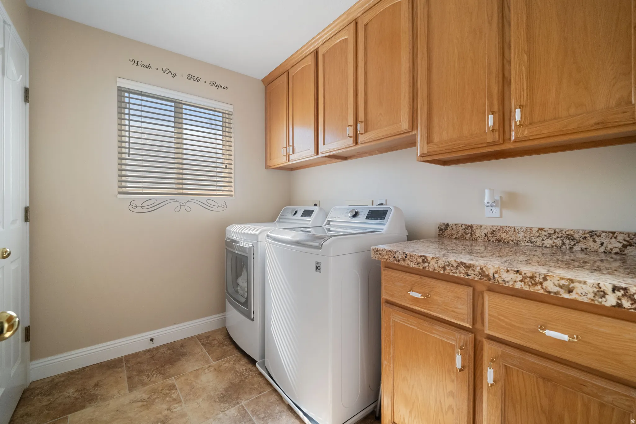 Mainfloor laundry room with added storage and linen closet.