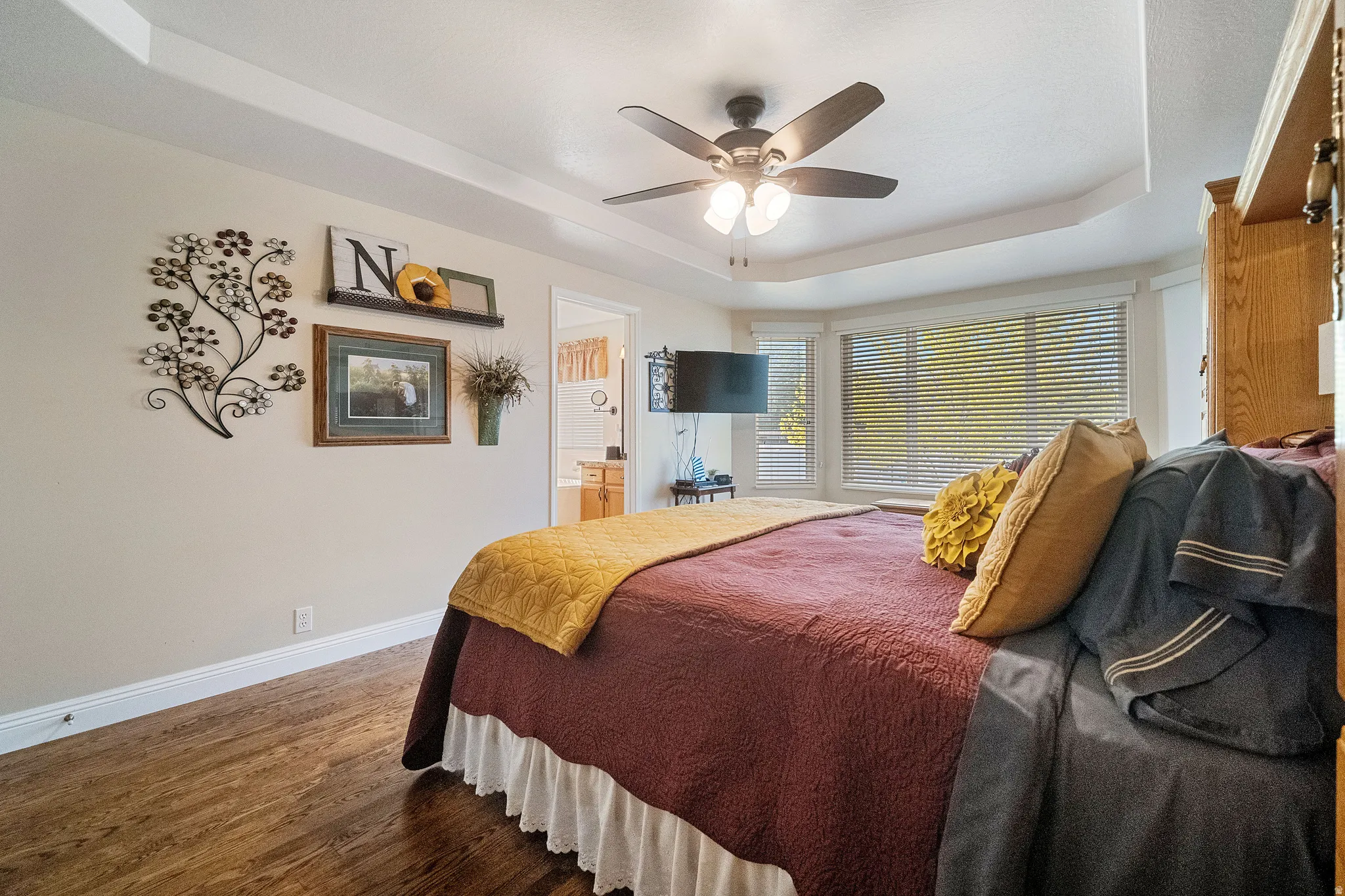 Bedroom features horizontal blinds and custom blackout shades.