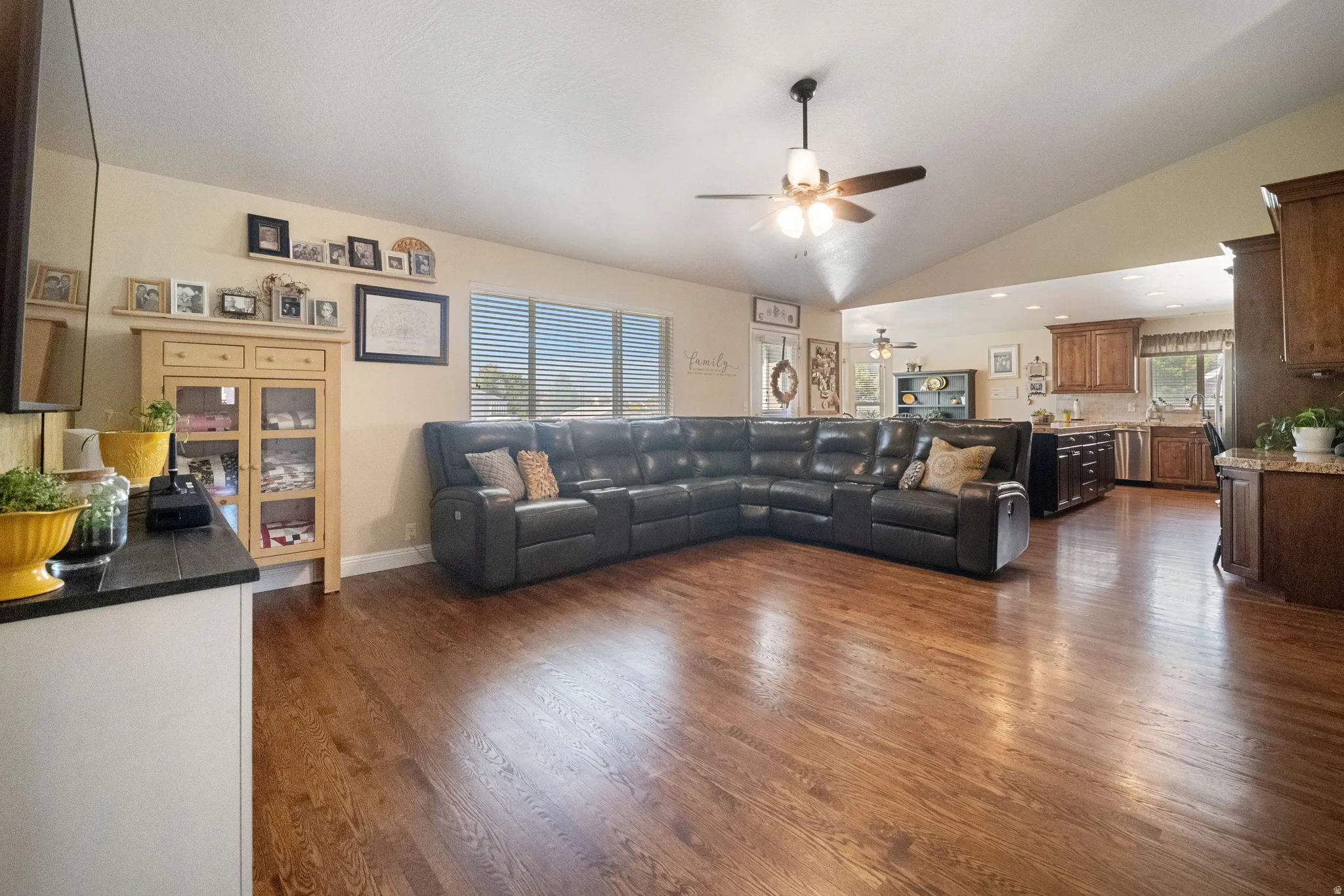Spacious living area featuring hardwood flooring and vaulted ceilings.