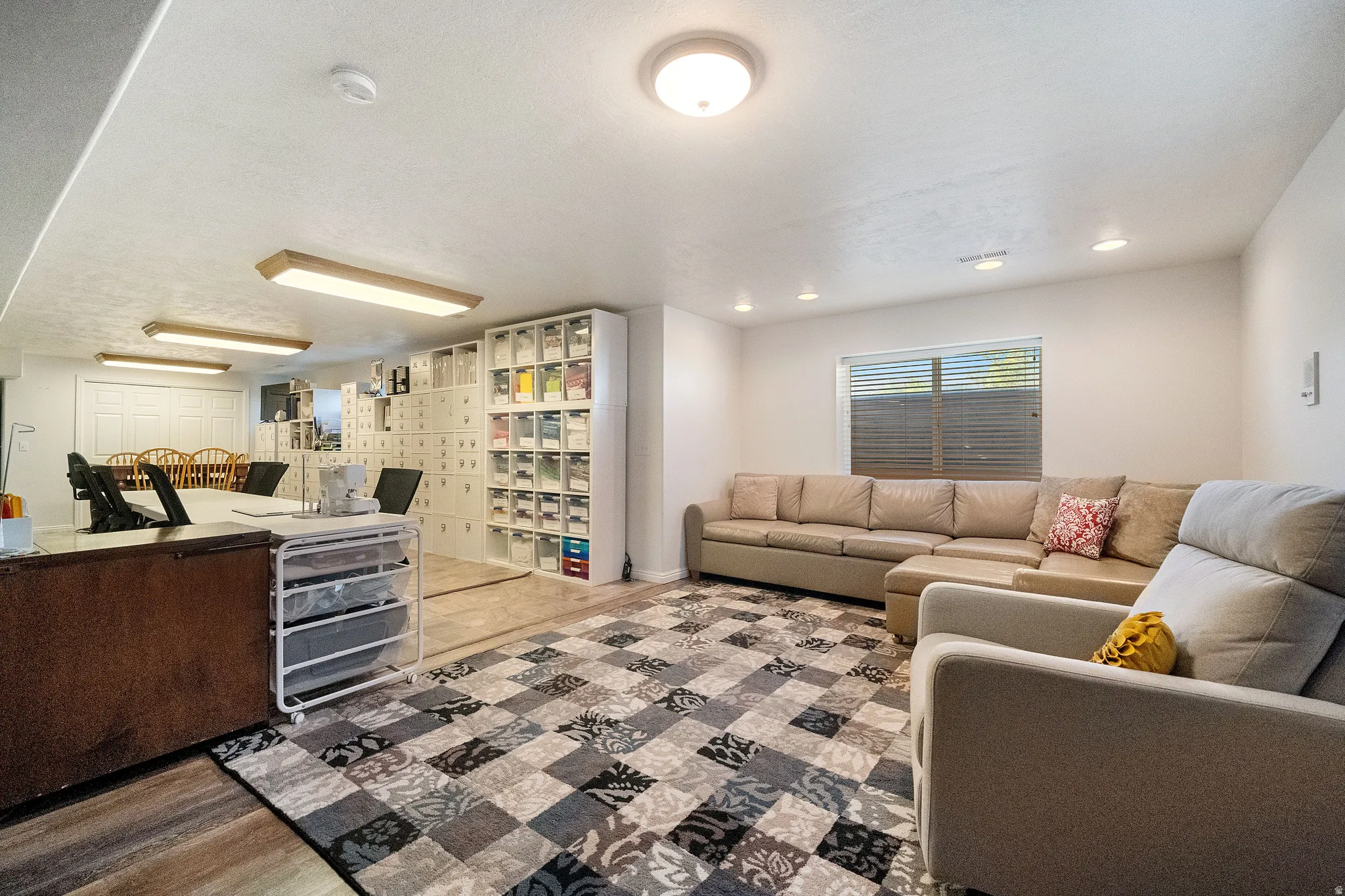 Versatile lower-level space featuring a window, built-in recessed lighting, and a neutral color palette
