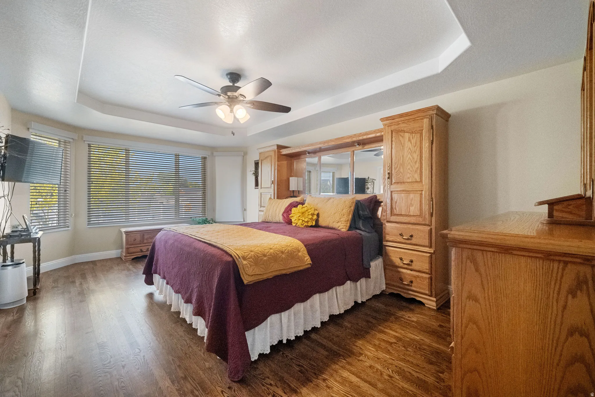 Primary suite on main floor with large windows and refinished harwood floors.