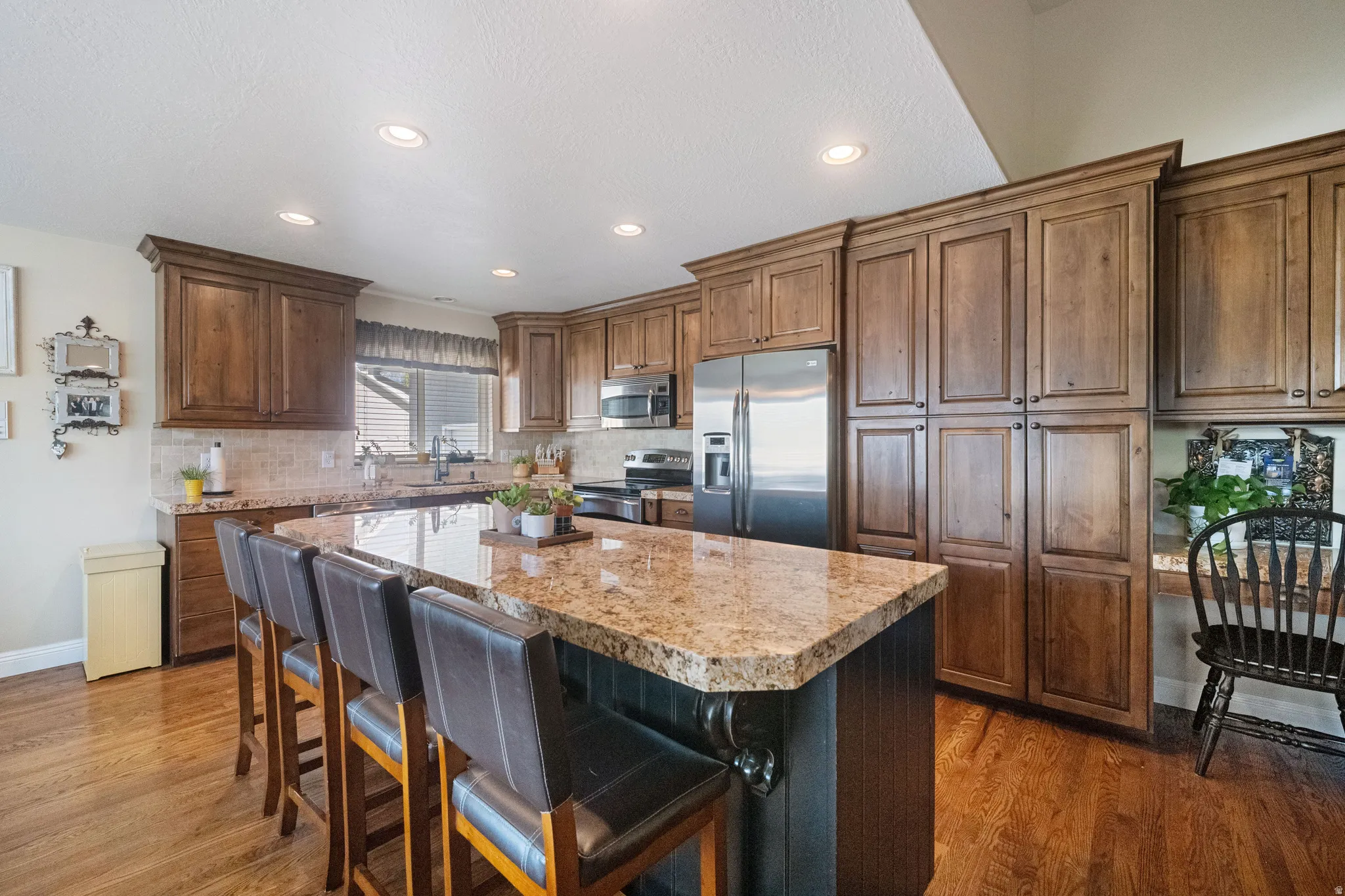 Remodeled kitchen with custom cabinets, oversized island and high-end granite.