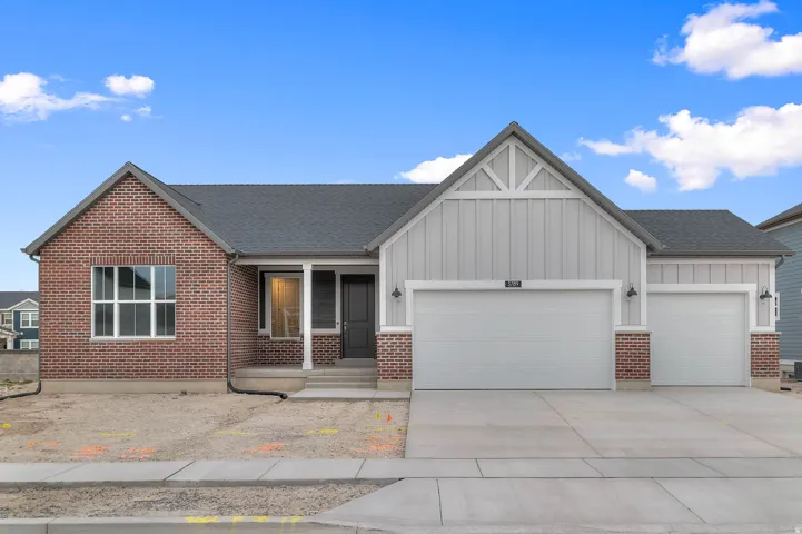 Ranch-style exterior featuring a combination of brick and vertical panel siding